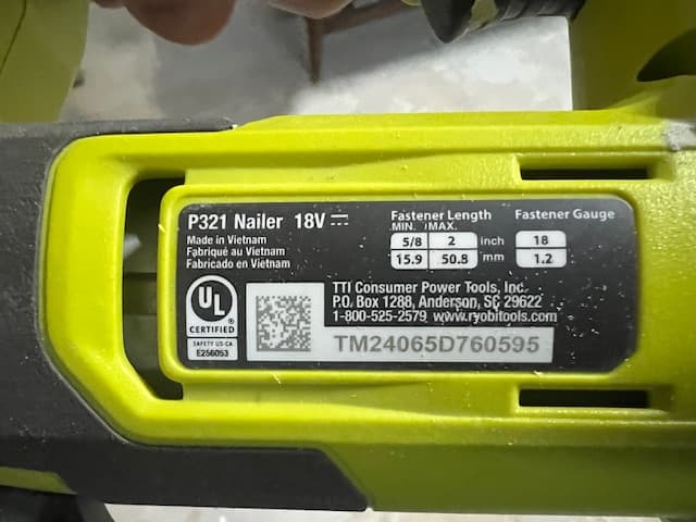 Close-up of the nailer specification label with serial number